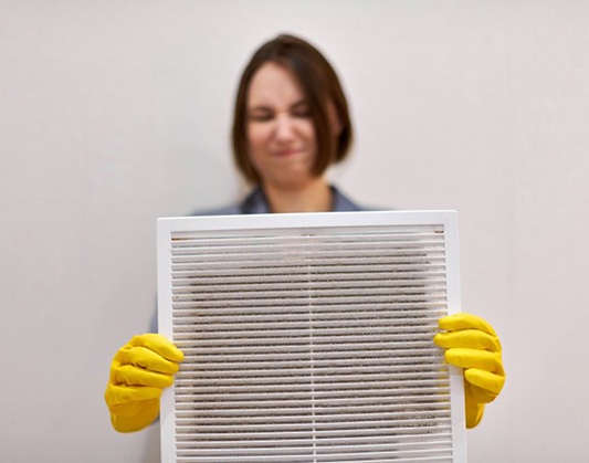 a technician placing the final touches to AC maintenance