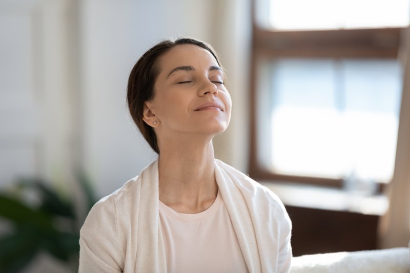 a woman enjoying her time breathing at home